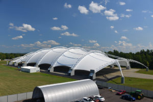 Reaching a maximum height of 115 feet, this 700-foot-long by 300-foot-wide dome engineered and fabricated by Dünn Lightweight Architecture is one of the largest fabric-covered structures in the U.S.  
