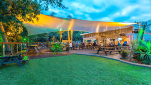 The Wickham Park Hotel of Newcastle, Australia, commissioned Shade to Order to design, fabricate and install a freeform tensile shade structure over its outdoor eating plaza. As a nod to the hotel’s nautical theme, the canted support columns are made of 400mm-diameter solid ironbark hardwood with flattop metal caps; the cable-edged fabric is 802 PVC-polyester from Serge Ferrari. Photo: Shade to Order Pty. Ltd.