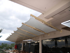 Tensile awnings grace the PGA West Stadium Clubhouse in La Quinta, Calif. Stainless steel catenary cables and fittings use pinned and bolted connections to ensure an economical and quick field installation. Photo: Eide Industries Inc. 