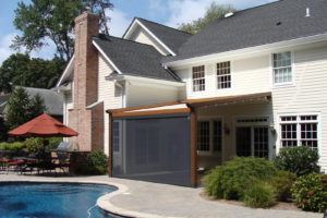The wooden Gennius, resembling a pergola, provides this private residence with a comfortable outdoor entertaining area, using a retractable awning that provides protection from both UV rays and inclement weather on the south-facing patio. Window Works of Livingston, N.J., did the installation. Photo: KE Durasol Awnings Inc.