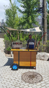 A flexible composite that includes integrated photovoltaic collection panels shades a portable iced-coffee station in Brooklyn. Photo: Pvilion