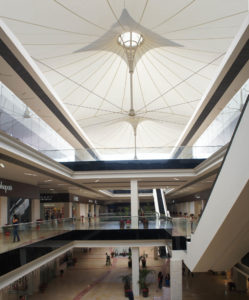 This view looks up from second level of Cuernavaca Mall atrium toward the flower-like flying masts that support and shape the fabric roof. A clear polycarbonate top cap lets in natural light but keeps out rain. Photo: Courtesy Valarias DRV