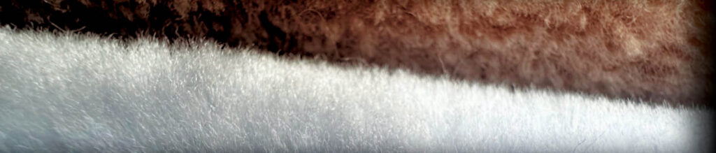 Close-up of textured, fluffy fabric in shades of brown and white, showcasing a blend of soft fibers and sustainable materials.